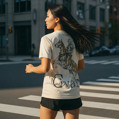 Woman running on a city street wearing a t-shirt with a graphic design and text.